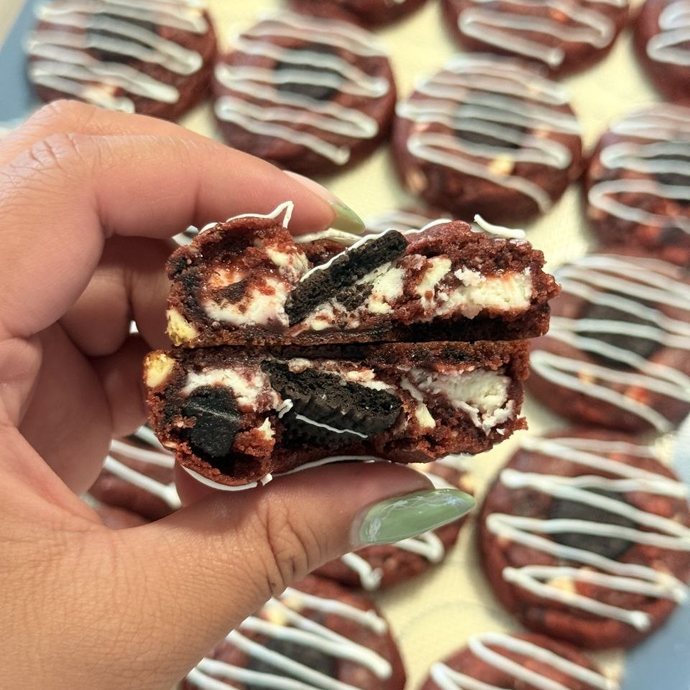 Red Velvet cookie split open, showing the cream cheese filling and Oreo pieces inside